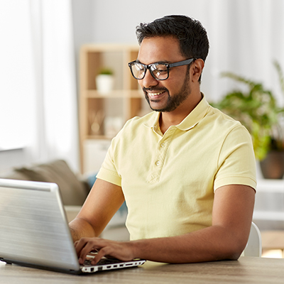 A person sat wokring on a laptop